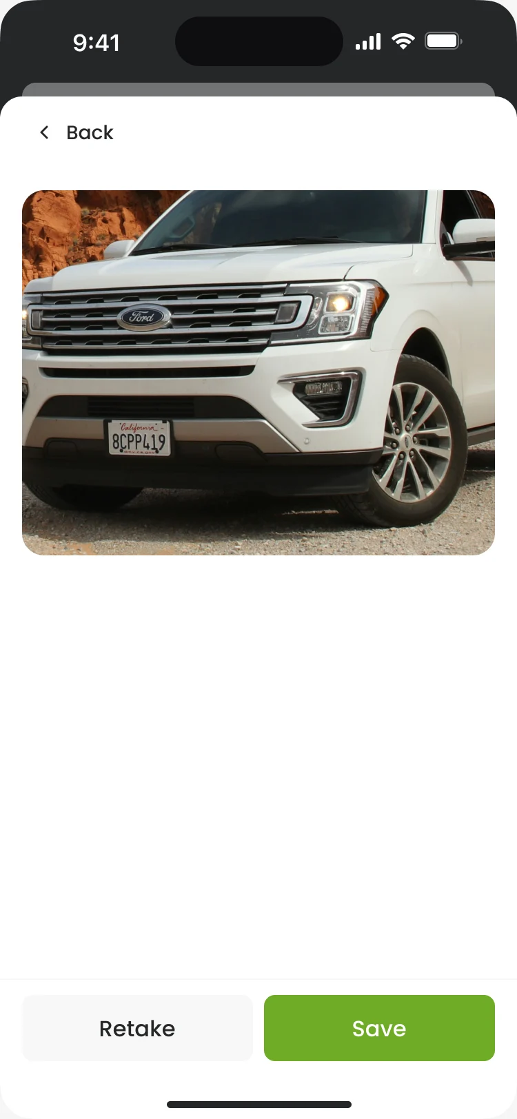 Add photo: a photo of a white SUV with Retake and Save