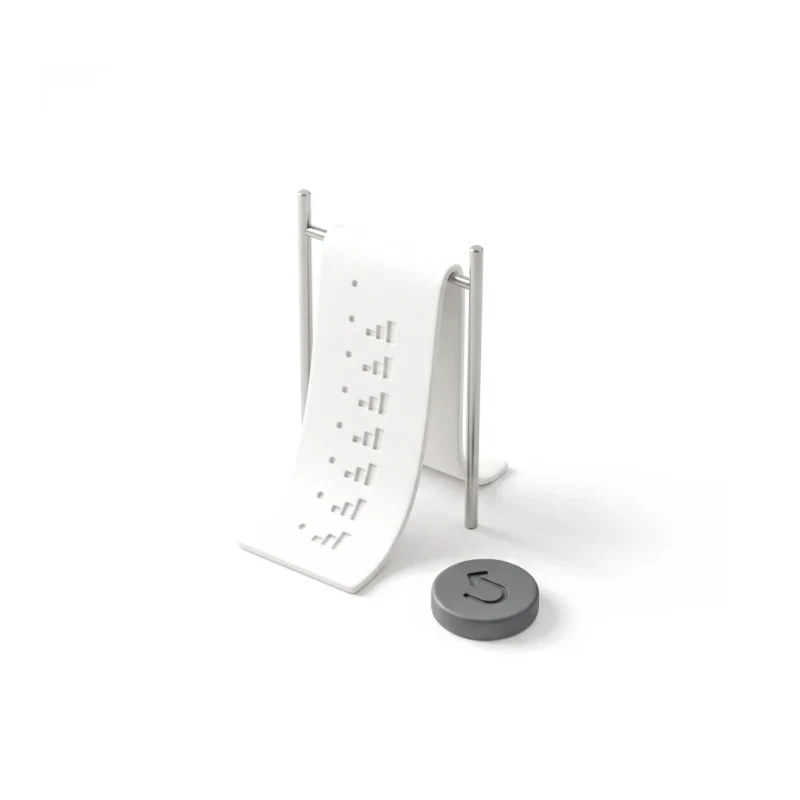 A ceramic log strip of step rows between steel rods, a round graphite undo button beside it.
