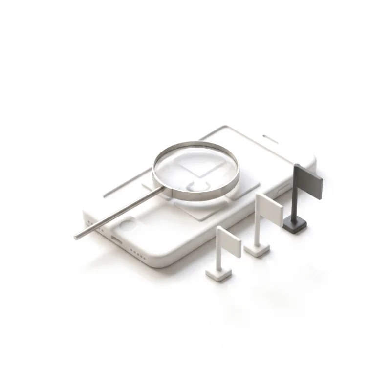 A ceramic phone under a steel magnifier, three flag pins of different heights along its edge, the tallest in graphite.