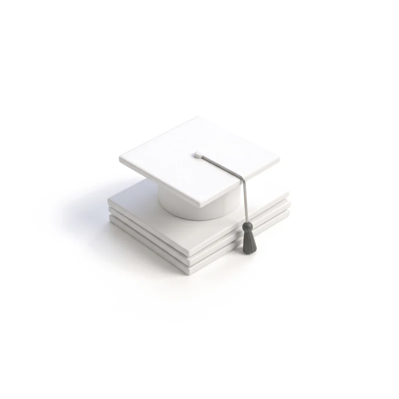 A white ceramic graduation cap on a stack of ceramic sheets, its steel tassel ending in graphite.