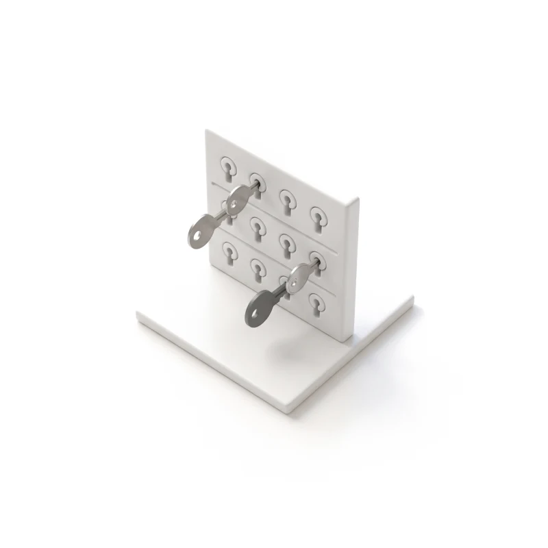 A white ceramic panel with rows of keyholes on a low base, two thin steel keys turned in their locks.