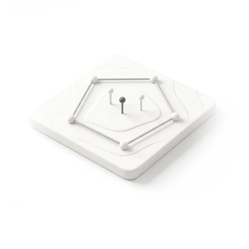 A ceramic terrain tile with a steel wire polygon, beads at its corners and three sample pins inside, one in graphite.