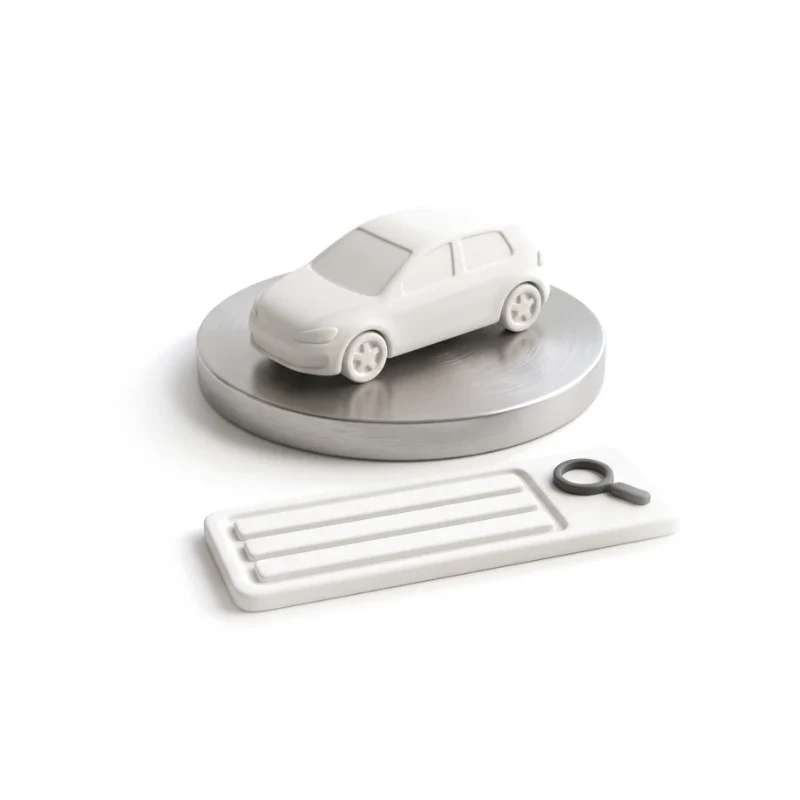 A white ceramic hatchback on a round steel turntable, a ceramic search tile with a graphite magnifier in front.