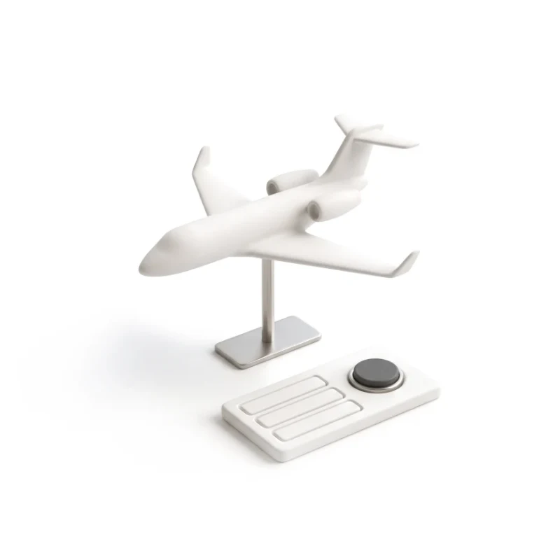 A ceramic business jet on a steel stand, a short request card with a graphite button in front.