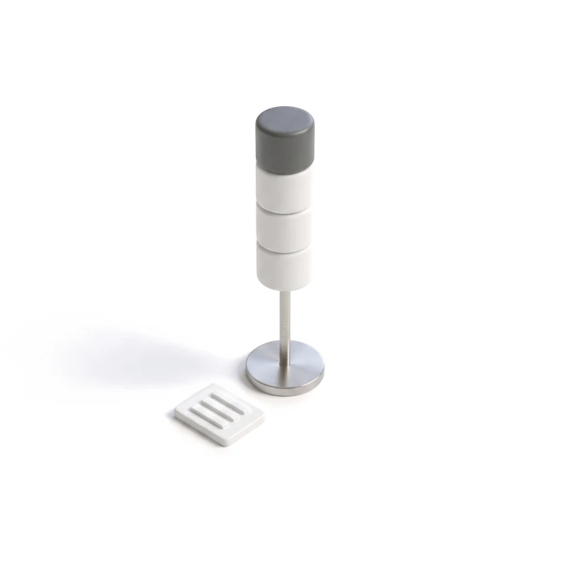 A white ceramic signal tower on a steel pole, the top segment graphite, a small alert tile beside it.