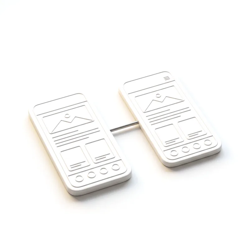 Two white ceramic phone slabs carved with wireframes, joined by a steel rod.