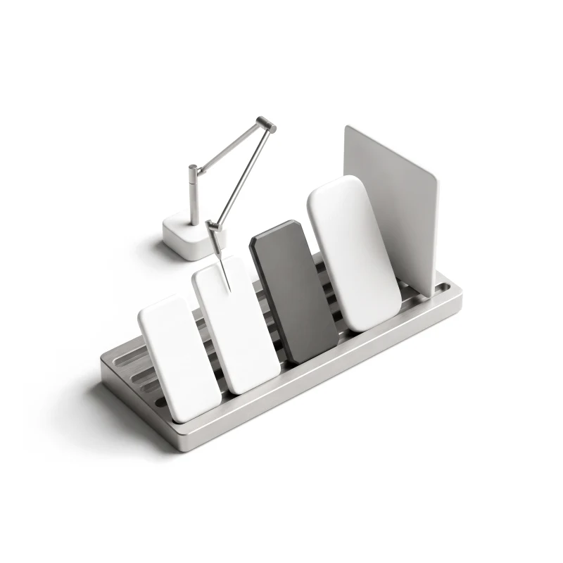 A steel test rack holding ceramic phones of different sizes and a tablet, one phone in graphite, a thin steel probe arm touching a screen.
