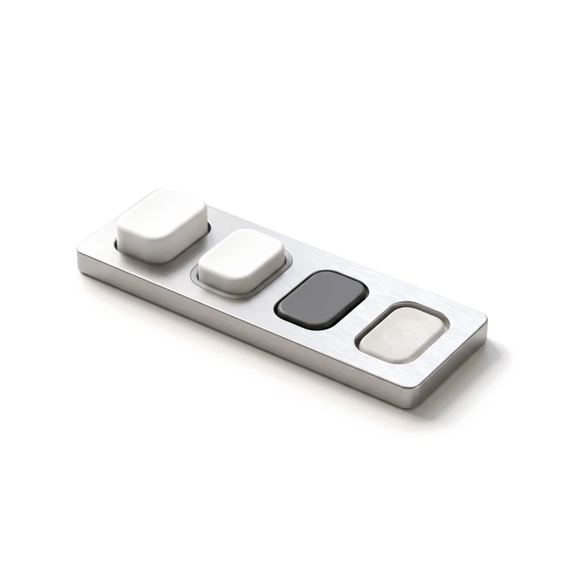 Four ceramic buttons in a steel tray: raised, hovered, pressed in graphite and faded as disabled.