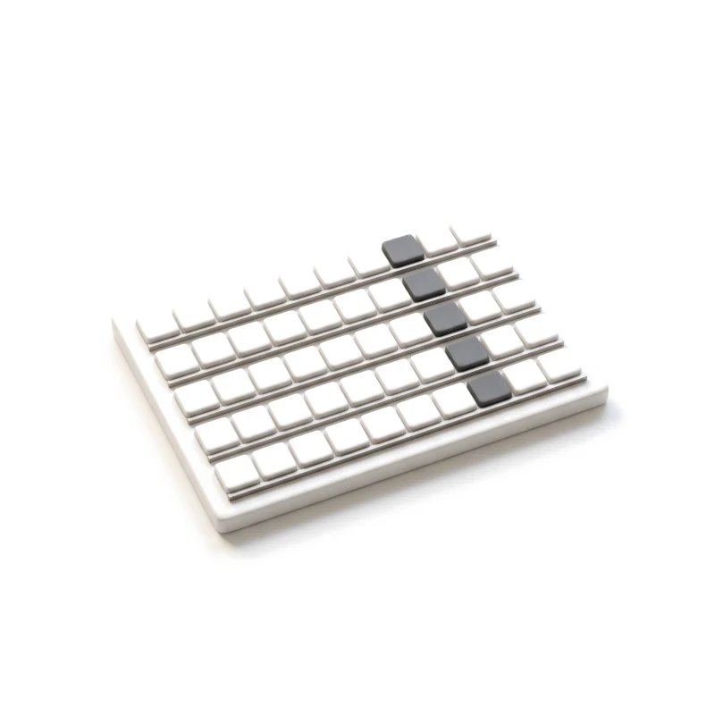 Rows of white ceramic tiles, with graphite tiles lined up at the same step in every row.