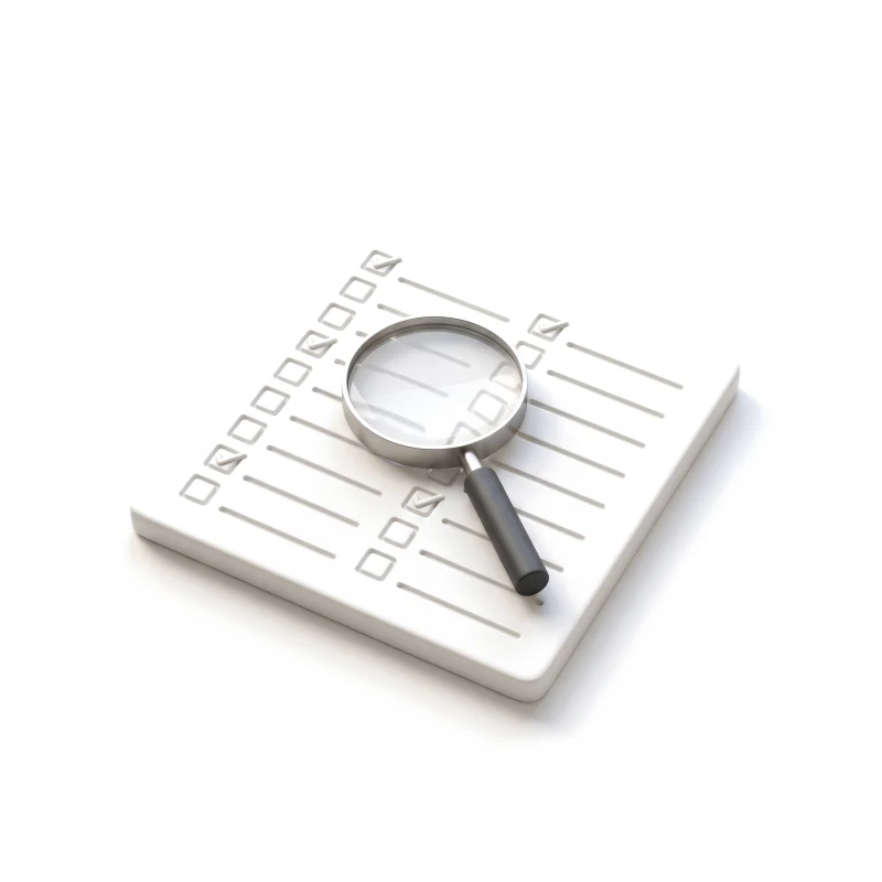 A white ceramic checklist slab with a few rows ticked, a steel magnifying glass with a graphite handle lying across it.