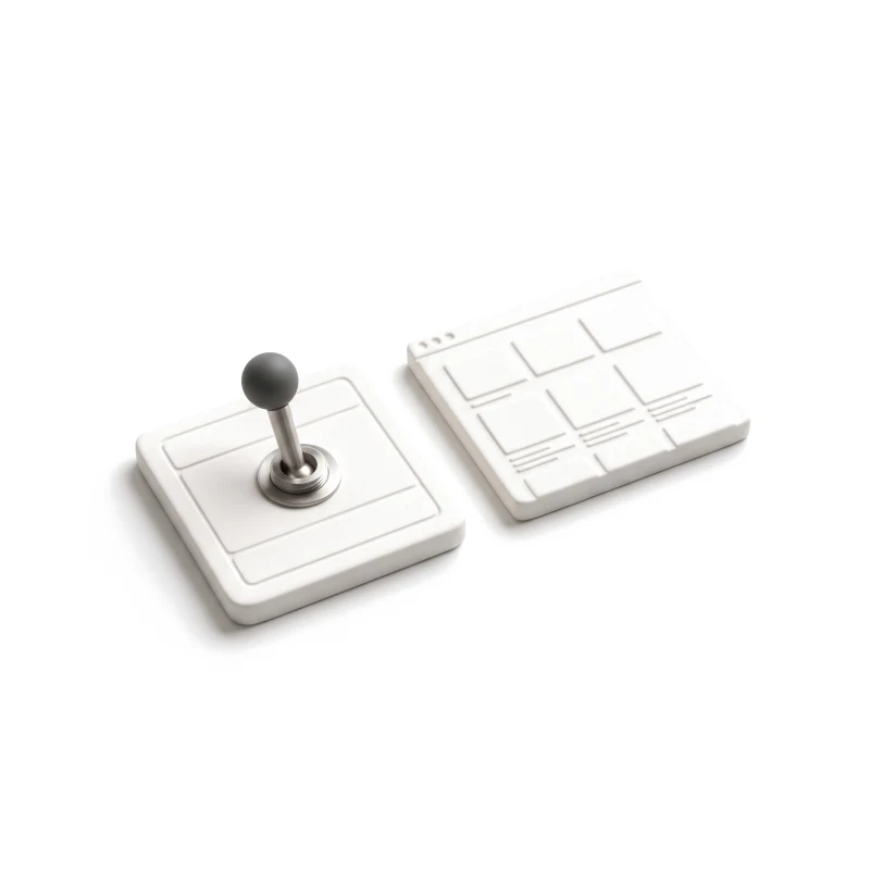 A ceramic switch plate with a steel toggle and a graphite knob, beside a small ceramic browser tile.
